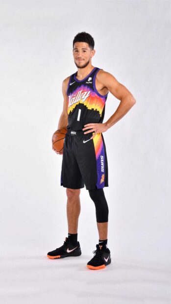 Devin Booker holds a basketball while wearing a Phoenix Suns jersey, 2K Phone Wallpaper