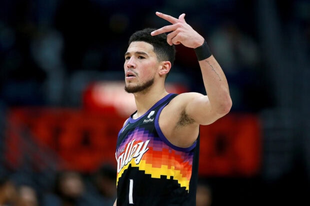 Devin Booker is seen celebrating during a game, HD Desktop Wallpaper