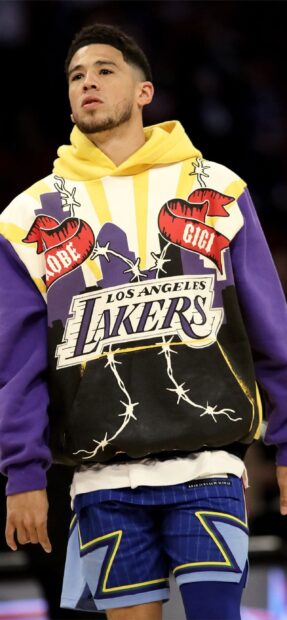 Devin Booker is wearing a Lakers hoodie and patterned shorts during a game, 2K Mobile Wallpaper