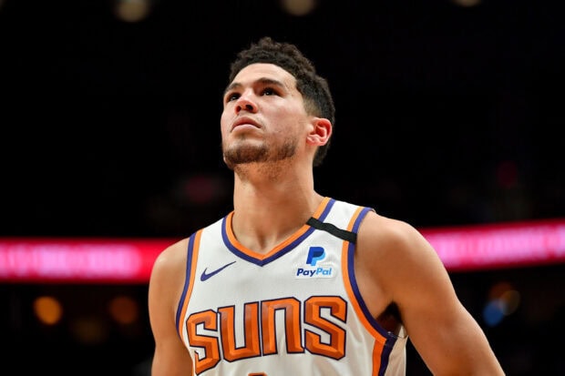 Devin Booker is focused during a basketball game wearing a Suns jersey, 2K Desktop Wallpaper