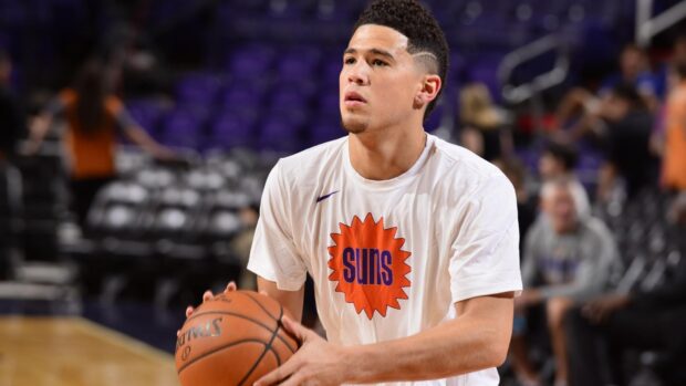 Devin Booker is focused on practicing his basketball shots during warm up, HD Desktop Wallpaper
