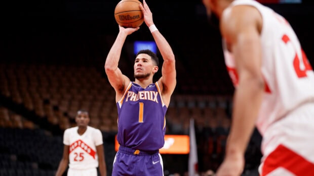 Devin Booker takes a jump shot in a basketball game wearing a Phoenix Suns jersey, HD Desktop Wallpaper