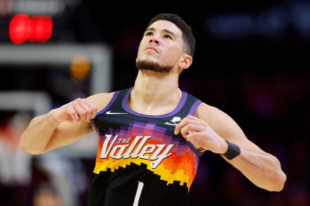 Devin Booker shows determination with his team jersey during the game, 2K Desktop Wallpaper