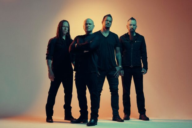 The rock band Disturbed stands together posing confidently in a studio photo, HD Desktop Wallpaper
