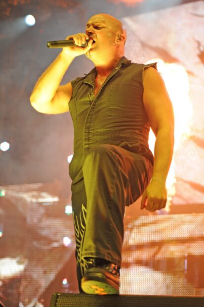 The lead singer of Disturbed passionately performs on stage during a live concert, HD Desktop Wallpaper