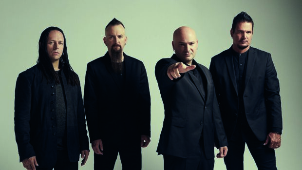 The members of Disturbed stand together wearing dark suits against a plain background, 2K Desktop Wallpaper