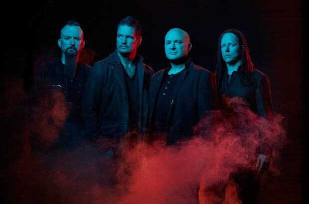 The disturbed band members stand in dark lighting with red smoke around them, HD Desktop Wallpaper