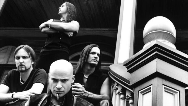 The Disturbed band members are standing and sitting on stairs in a black and white setting, HD Desktop Wallpaper