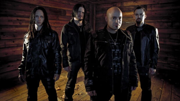 The Disturbed band members are standing together in a dimly lit wooden room wearing dark clothing, HD Desktop Wallpaper