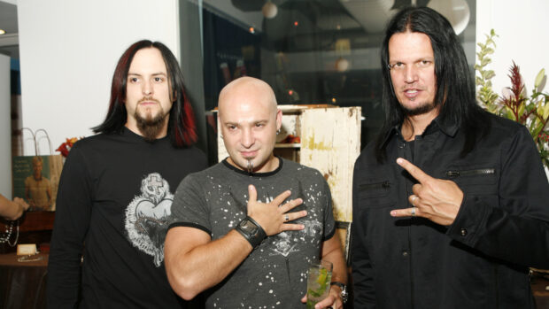 Three band members of Disturbed standing indoors with drinks, HD Desktop Wallpaper