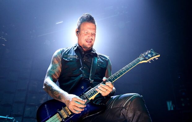 A guitar player from Disturbed performing live with intense lighting, HD Desktop Wallpaper