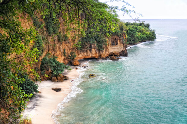 A beautiful coastal area on Dominica Island showing clear water and rocky cliffs, 2K Desktop Wallpaper