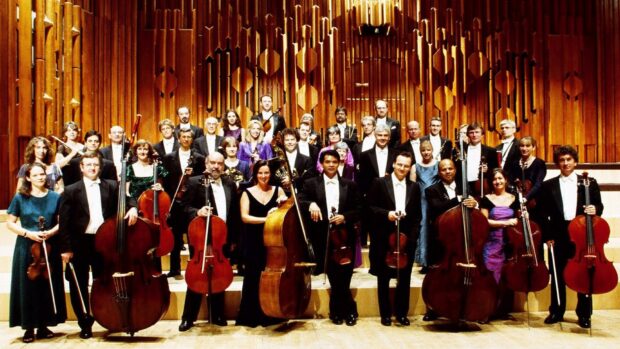 A group of musicians holding double bass instruments in an ornate concert hall, HD Desktop Wallpaper