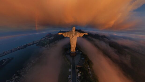 The Christ The Redeemer statue stands tall amid clouds at sunset, HD Desktop Wallpaper
