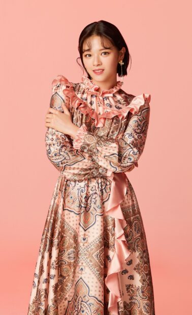 Jeongyeon Twice wallpapers shows her in a detailed patterned dress with soft pink background, HD Mobile Wallpaper