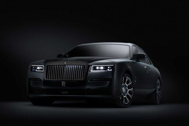 A sleek Rolls Royce Ghost with illuminated headlights in a dark environment, HD Desktop Wallpaper