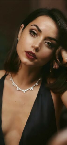 A close up of a woman wearing a black dress and a silver necklace from No Time To Die Wallpapers, HD Mobile Wallpaper