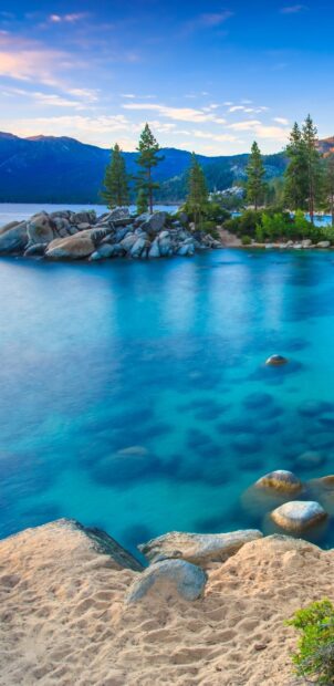A scenic view of Lake Tahoe Emerald Bay with clear blue water and pine trees, HD Mobile Wallpaper