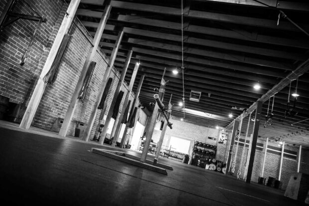 An empty Crossfit gym with barbells and ropes ready for workout sessions, HD Desktop Wallpaper