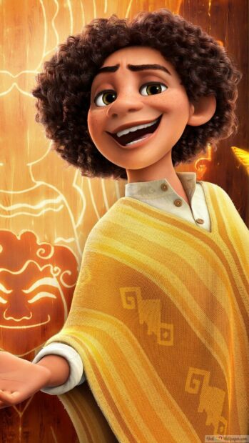 A smiling character from Encanto is shown with a glowing orange background and yellow patterned clothing, HD Phone Wallpaper