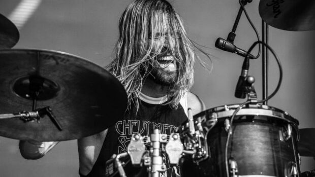 A Foo Fighters drummer passionately plays the drums during a concert, HD Desktop Wallpaper