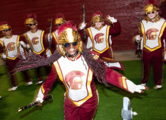A marching band performs with lively energy in uniform and helmets, 2K Desktop Wallpaper
