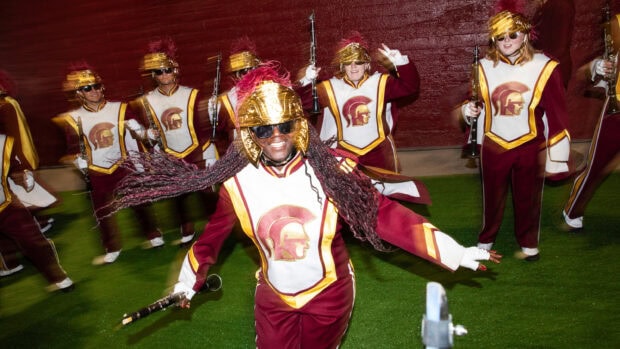 A marching band performs with lively energy in uniform and helmets, 2K Desktop Wallpaper
