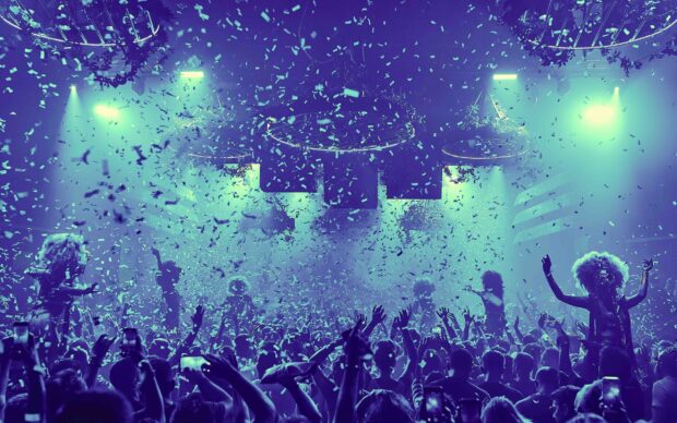 A lively nightclub scene with confetti and dancers entertaining a large crowd at night, 2K Desktop Wallpaper