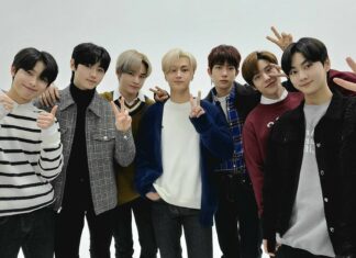 The Enhypen members show hand signs and pose for a group photo in casual outfits, HD Desktop Wallpaper