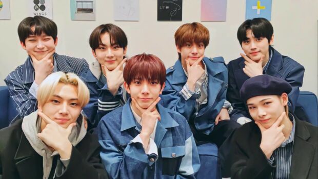 The Enhypen group is posing with hand gestures and smiling in a casual setting, HD Desktop Wallpaper