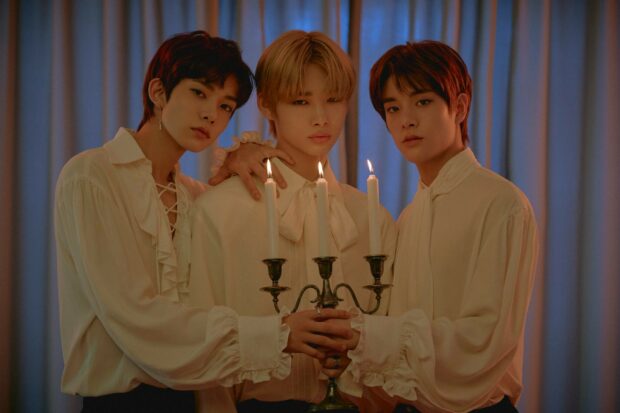 Three Enhypen members in vintage outfits stand holding a candle holder with lit candles, HD Desktop Wallpaper