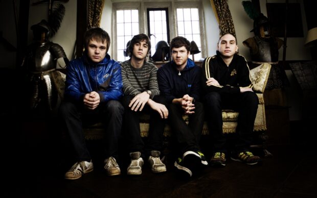 Enter Shikari band sitting on a vintage sofa with medieval armor behind, HD Desktop Wallpaper