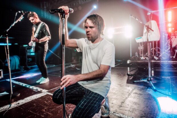 The Enter Shikari band is seen performing passionately during a concert, HD Desktop Wallpaper