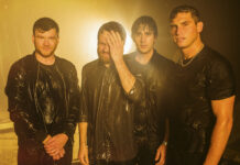 Rain-soaked band members in black leather jackets at night.
