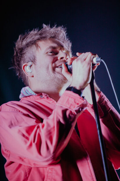 A close up of an Enter Shikari band member singing into a microphone, HD Phone Wallpaper