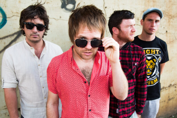 Enter Shikari band members standing together near a wall with one adjusting his sunglasses, HD Desktop Wallpaper