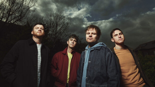 Enter Shikari band posing outdoors under dark cloudy sky, HD Desktop Wallpaper