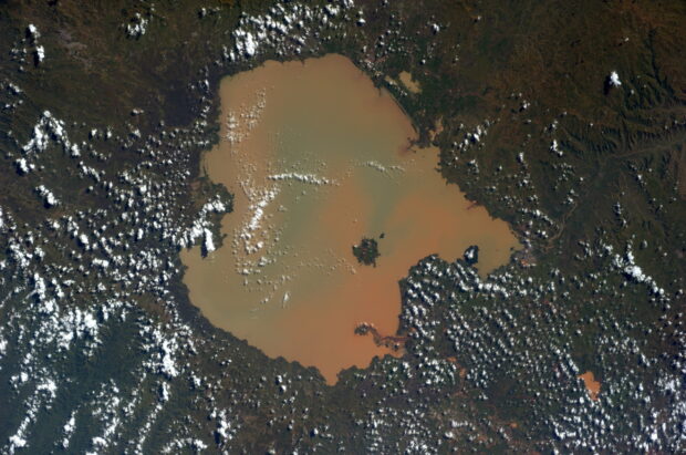A satellite view shows a large lake surrounded by green land and scattered clouds in Ethiopia, 2K Desktop Wallpaper