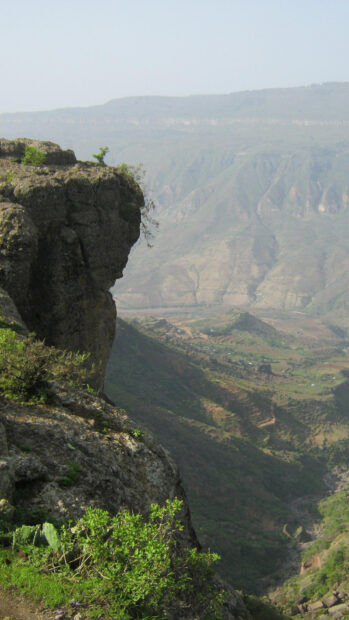 A view of Ethiopian mountain cliffs and green valley under a clear sky, HD Mobile Wallpaper