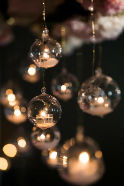 Glass ornaments with candles creating a fairy lights effect in a dark setting