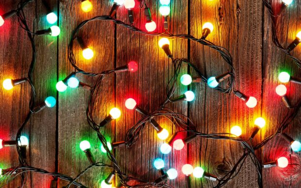 Colorful fairy lights brightening up a wooden surface with warm glowing bulbs