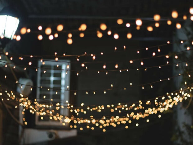 Warm fairy lights glowing softly in a nighttime outdoor setting