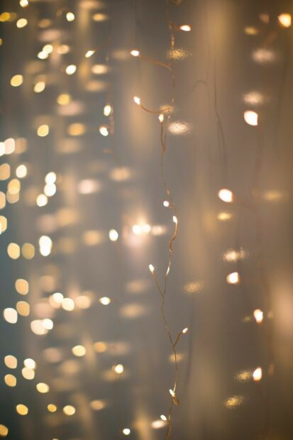 Warm fairy lights creating a cozy glow on a blurred background with gentle light reflections