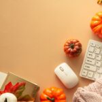 A cozy office desk decorated with pumpkins and autumn leaves for Fall
