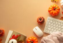 A cozy office desk decorated with pumpkins and autumn leaves for Fall