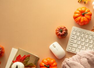 A cozy office desk decorated with pumpkins and autumn leaves for Fall