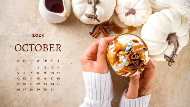 Hands holding a warm pumpkin spice drink with an October calendar for Fall 2025