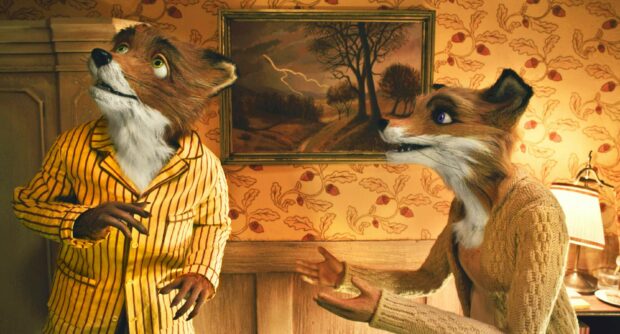 Two fox characters from Fantastic Mr Fox wearing clothes indoors with a framed painting in the background
