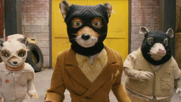 A Fantastic Mr Fox character wearing a mask and coat with two animal companions in an alley