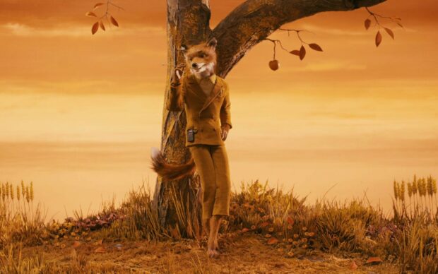 Fantastic Mr Fox character standing by a tree in an autumn landscape
